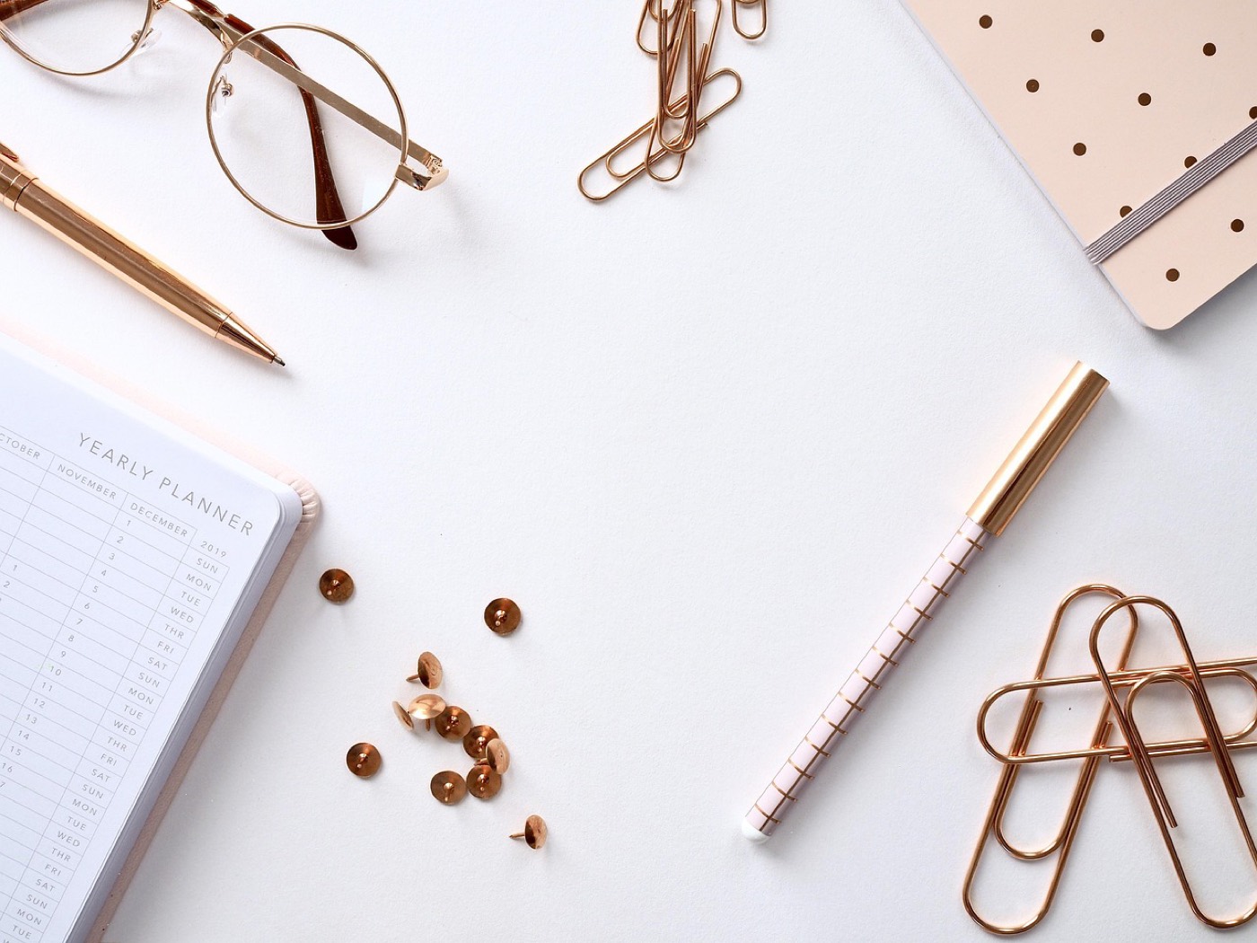 A writing desk with a notebook and camera
