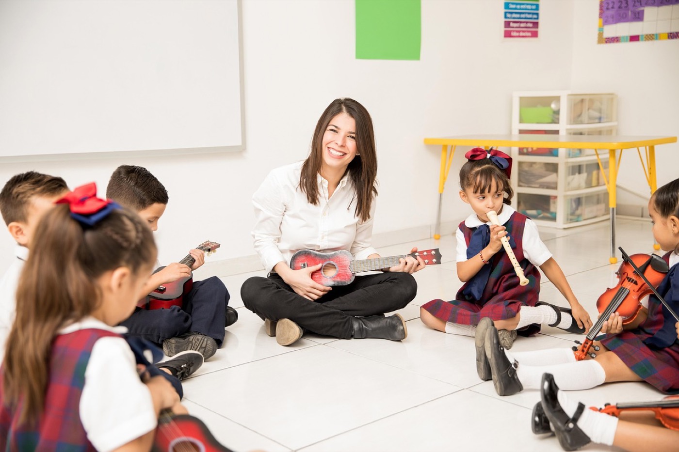 A teacher working with students in a classroom