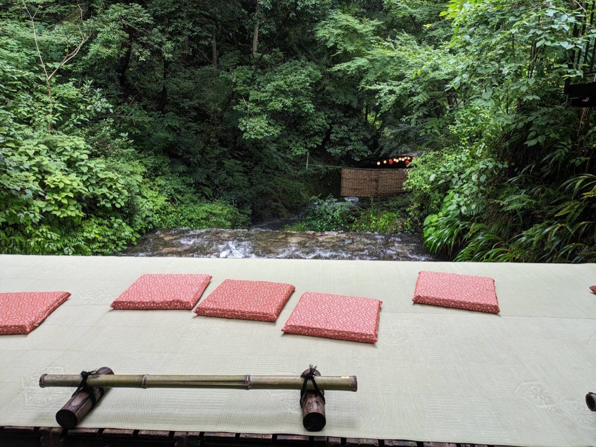 Kawadoko riverside dining platform with cushions above a mountain stream